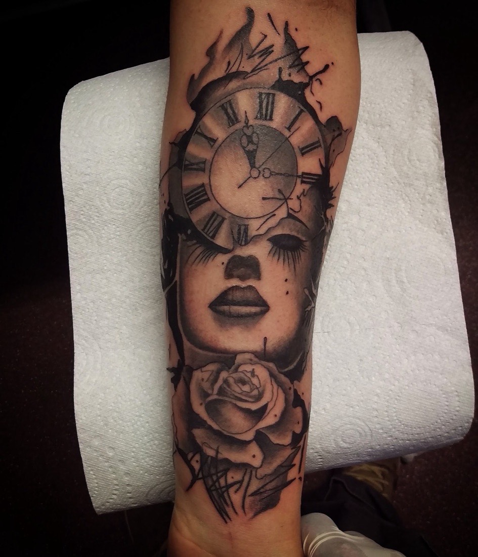 Black and grey portrait tattoo of a woman with a clock and rose on a forearm, by Scorpion Ink