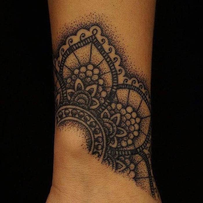 Geometric dotwork mandala tattoo around an ankle, by Scorpion Ink